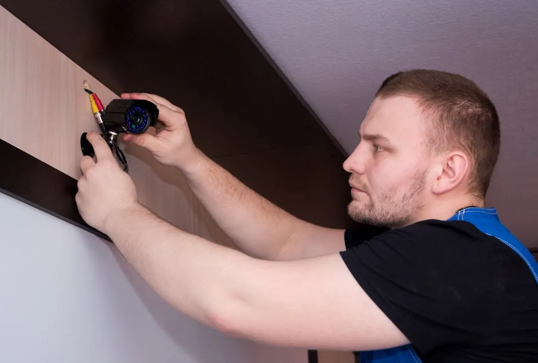 Technician measuring inside an attic