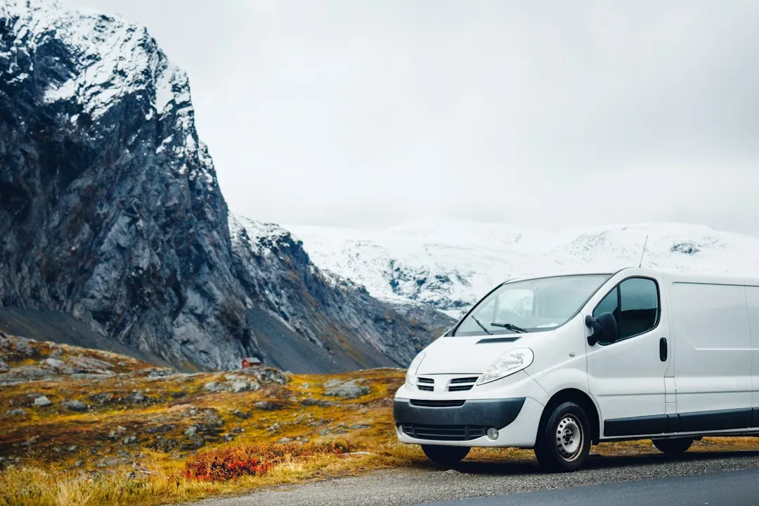 White service van in a wide natural landscape